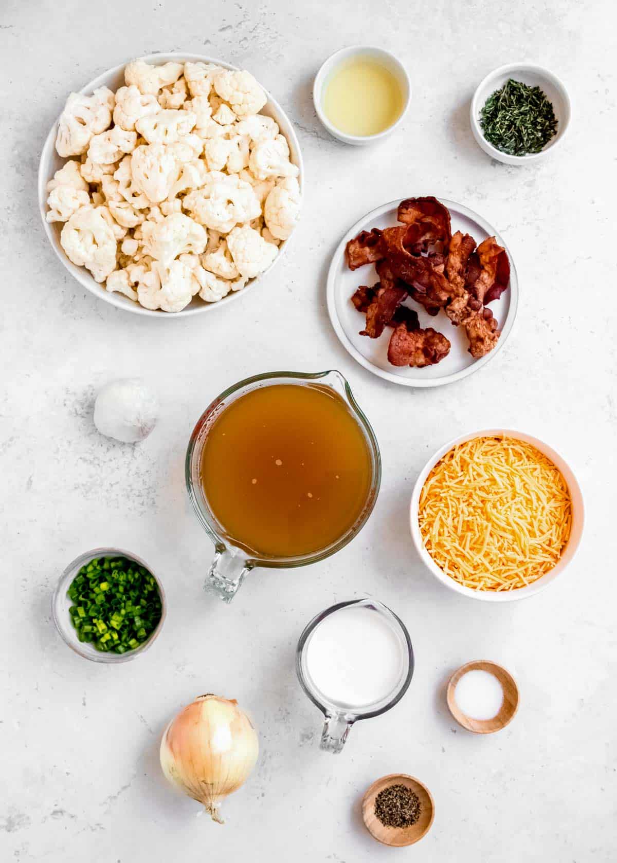 loaded cauliflower soup ingredients on a white table