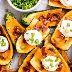 overhead image of a stack of loaded zucchini skins on a sheet pan