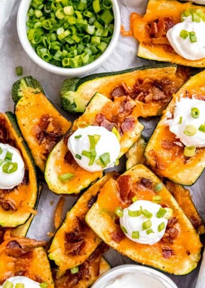 overhead image of a stack of loaded zucchini skins on a sheet pan