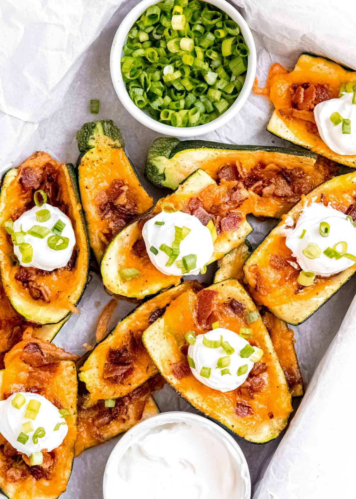 a stack of loaded zucchini skins on a sheet pan