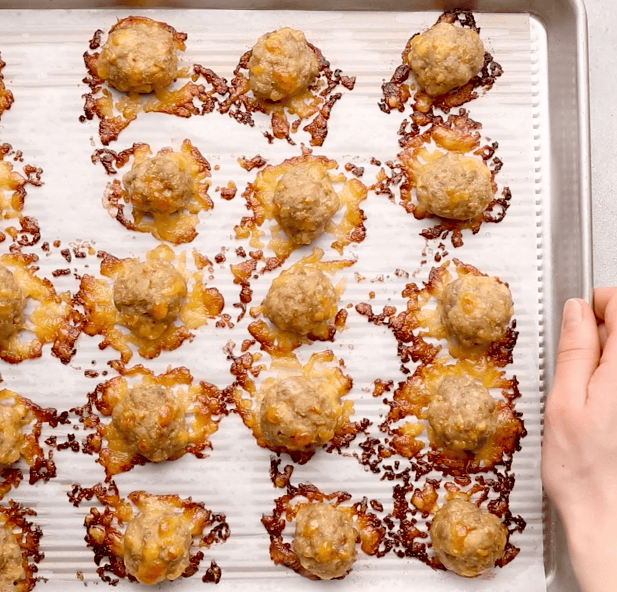 cooked sausage balls on sheet pan after removing from oven