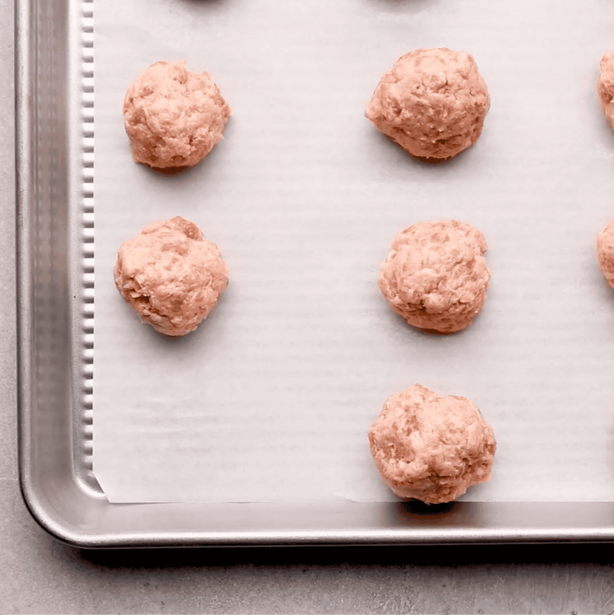 raw sausage balls on sheet pan