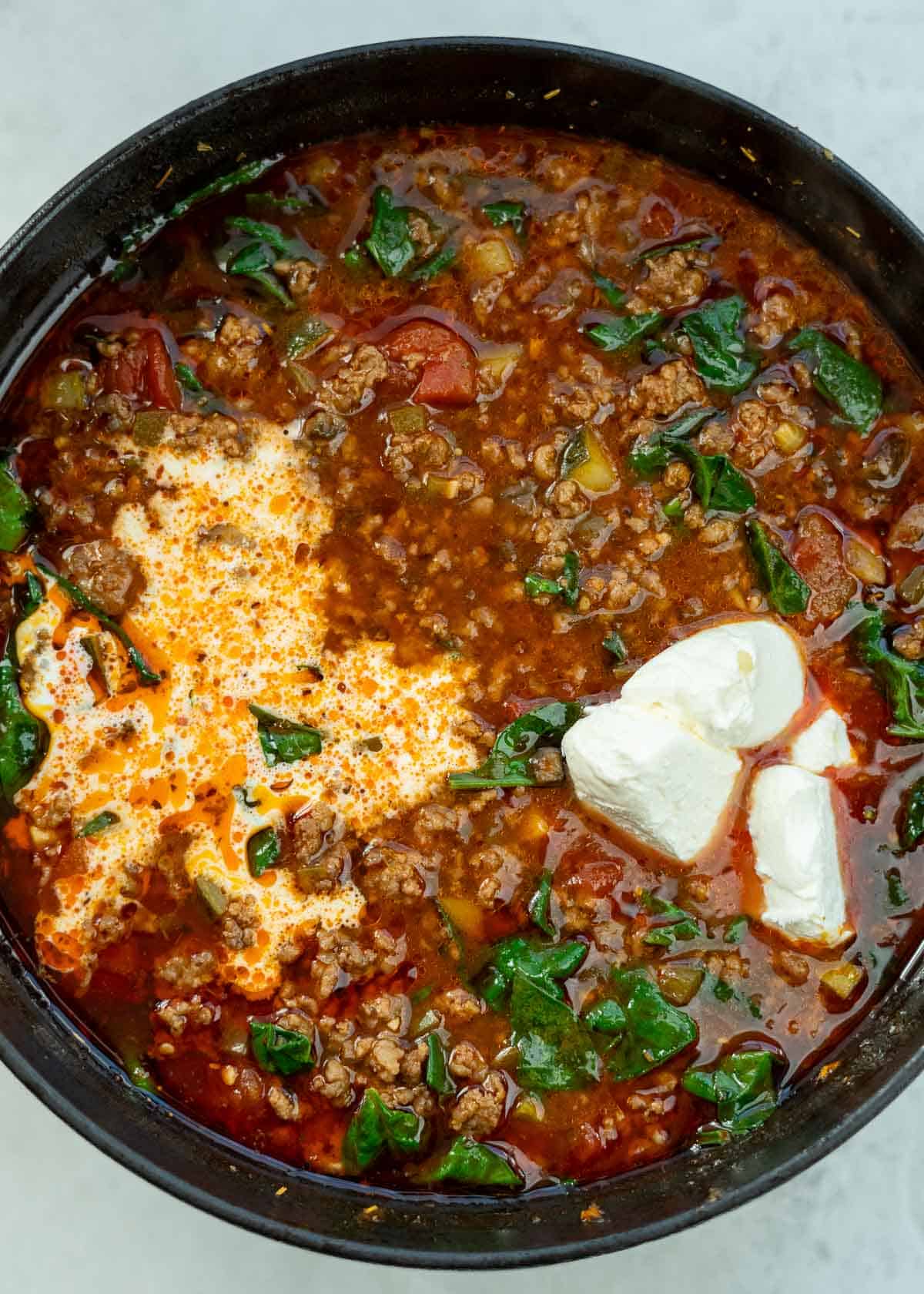 heavy cream being added to pizza soup