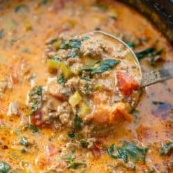 overhead image of spoonful of pizza soup being removed from pot