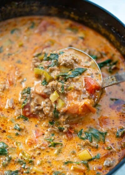 overhead image of spoonful of pizza soup being removed from pot