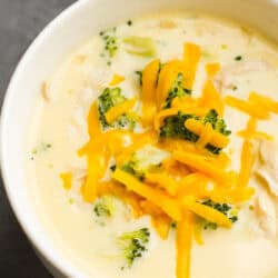 overhead image of broccoli cheese soup in white bowl