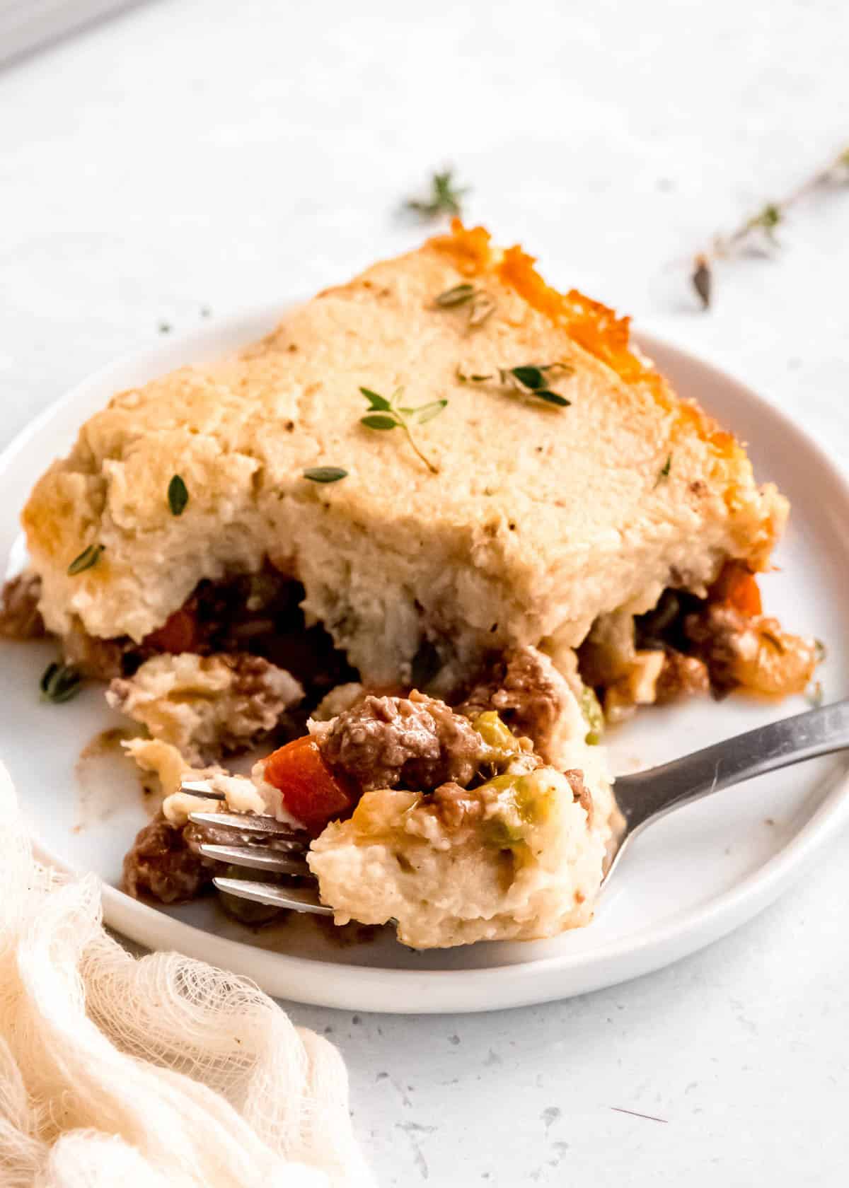 a bite of keto shepherd's pie being removed from plate with a fork