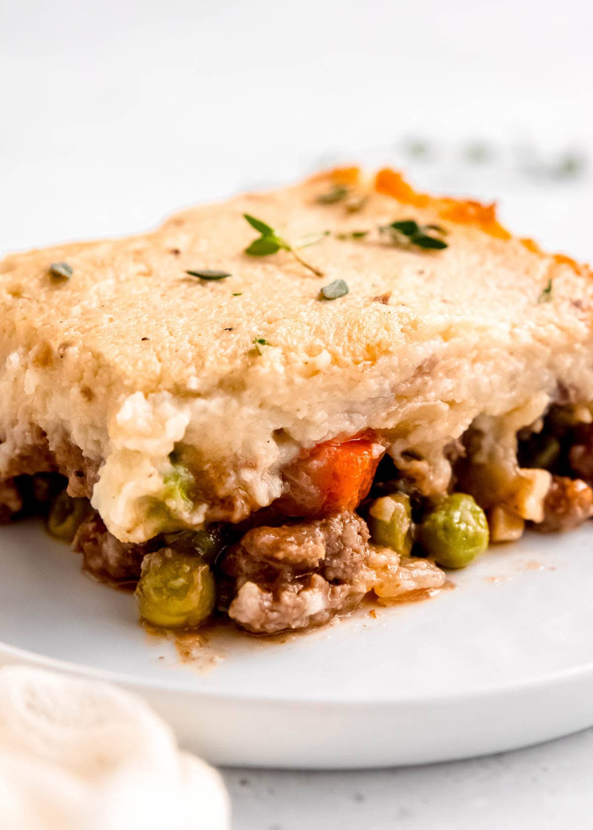 side image of a slice of keto shepherd's pie on a white plate