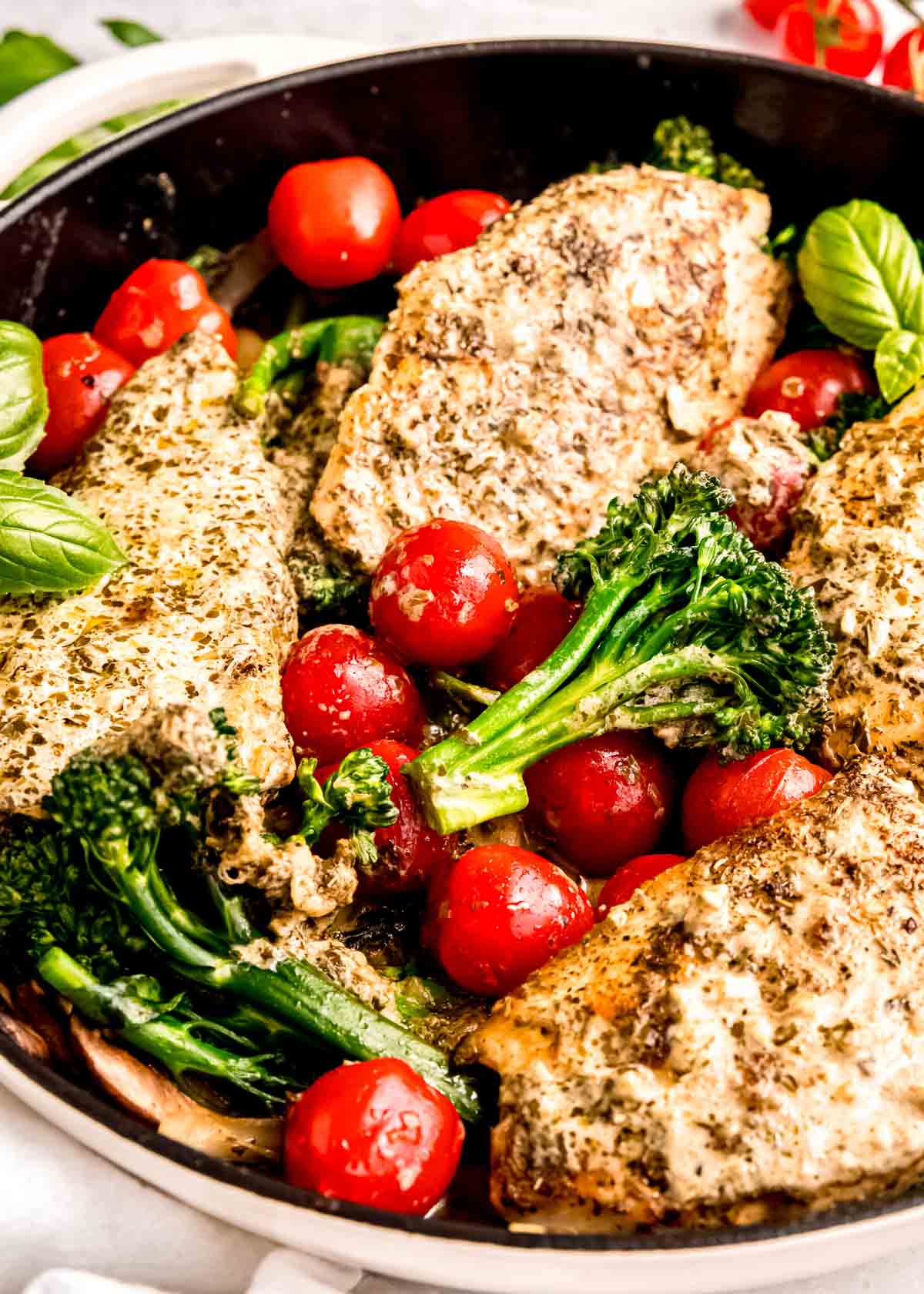 close up image of cooked chicken pesto skillet