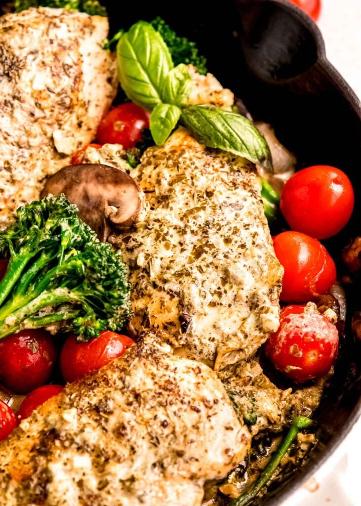 close up image of pesto chicken in cast iron skillet