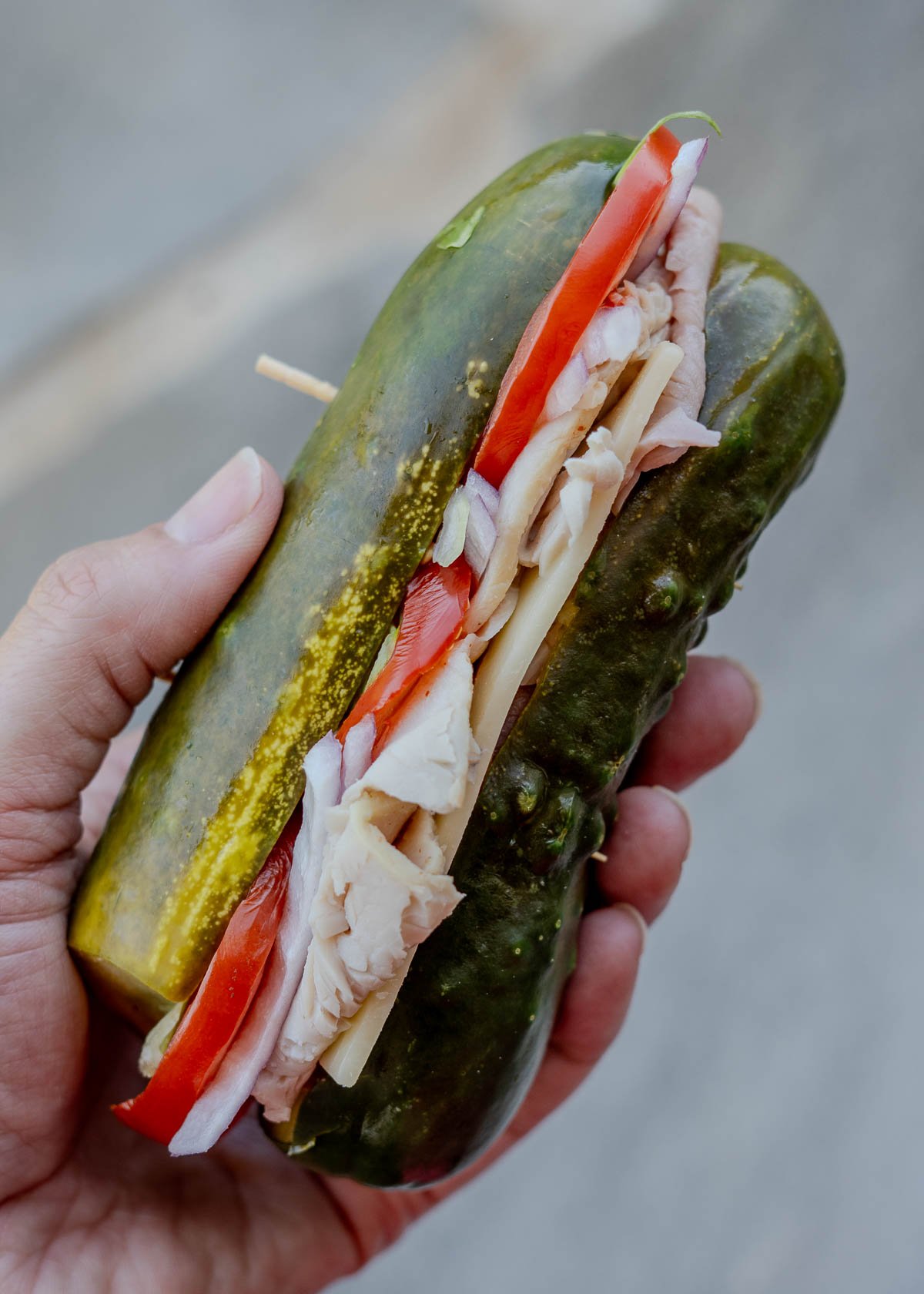 a close up shot of a pickle sandwich