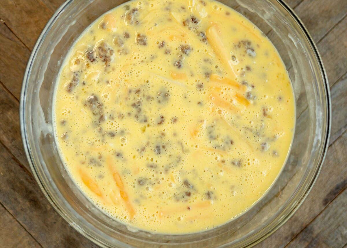 egg and sausage mixture in a clear mixing bowl