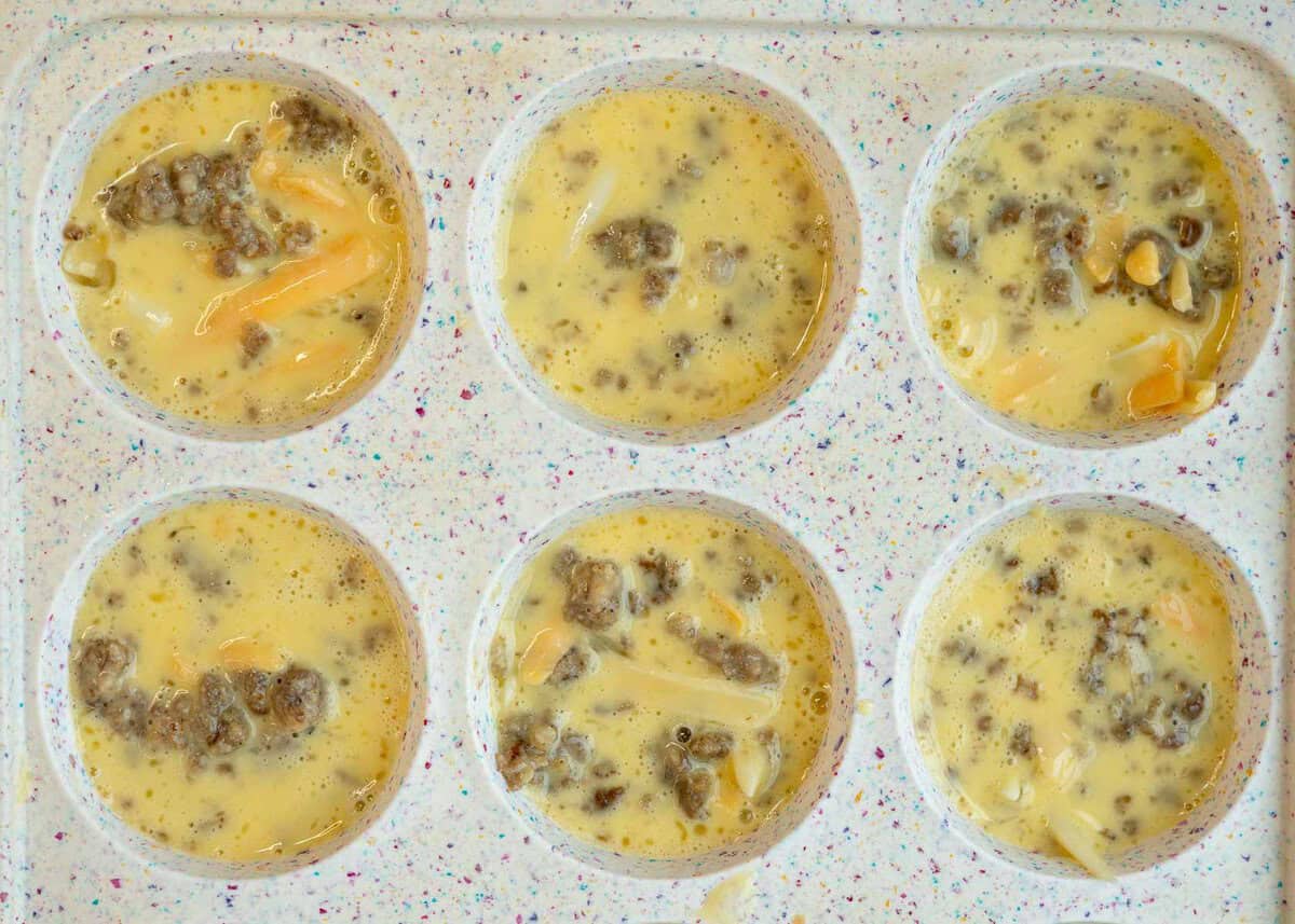 sausage egg mixture after being added to muffin tins