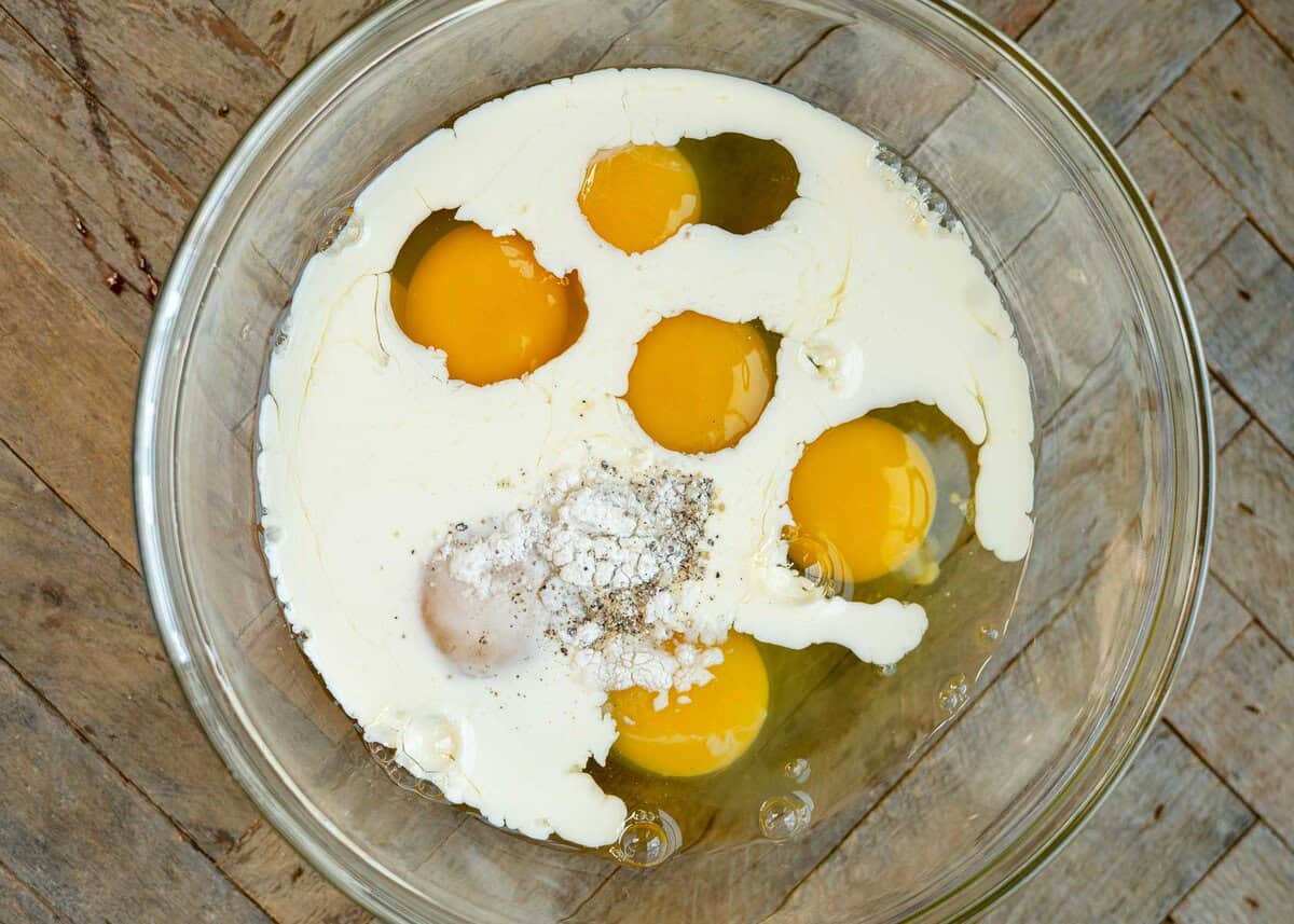 egg muffin ingredients prior to mixing in clear bowl