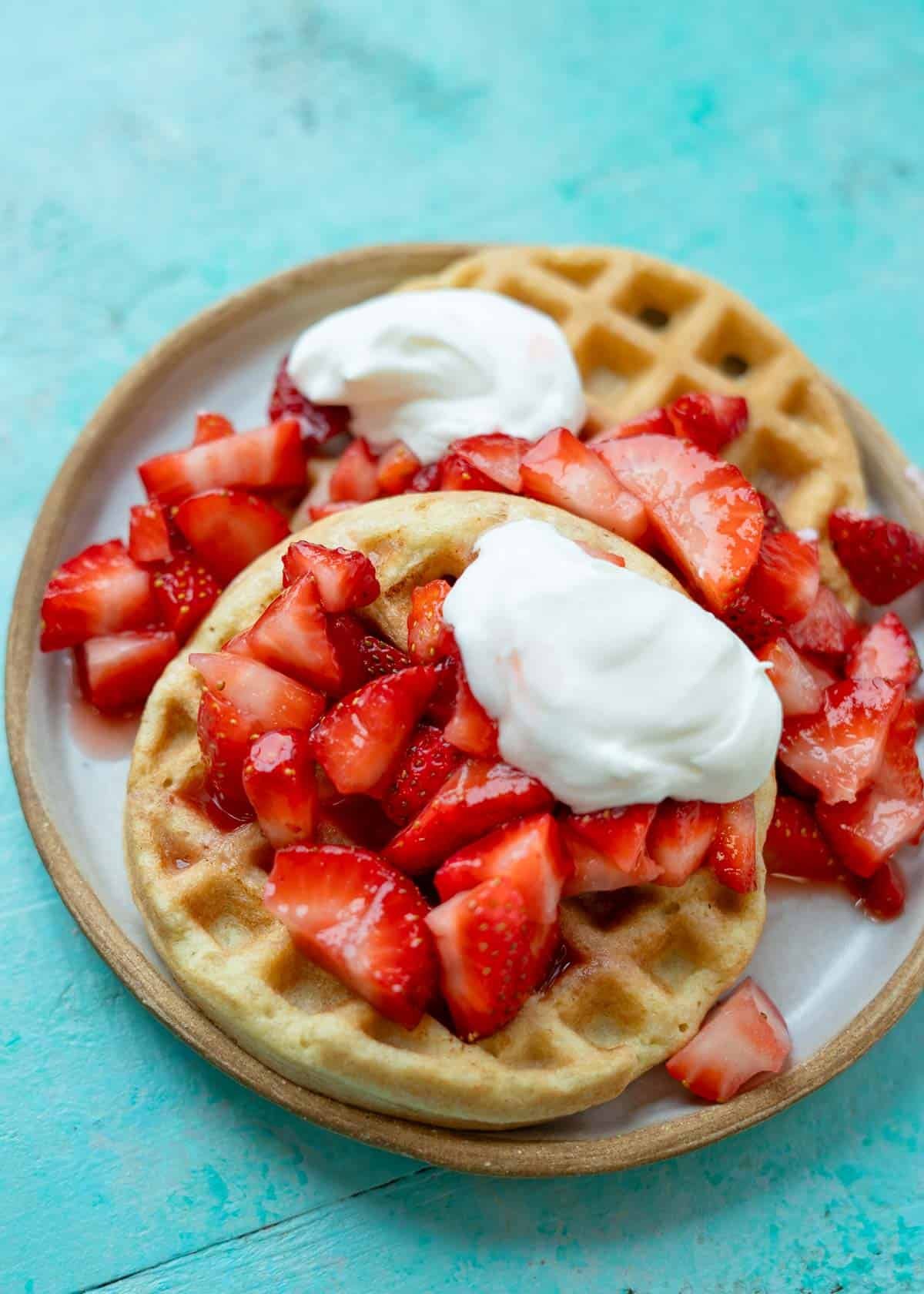 assembled strawberry shortcake waffles on a plate
