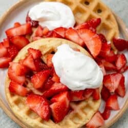 Strawberry waffles with whipped cream.