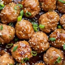 a close up shot of cooked meatballs in a skillet
