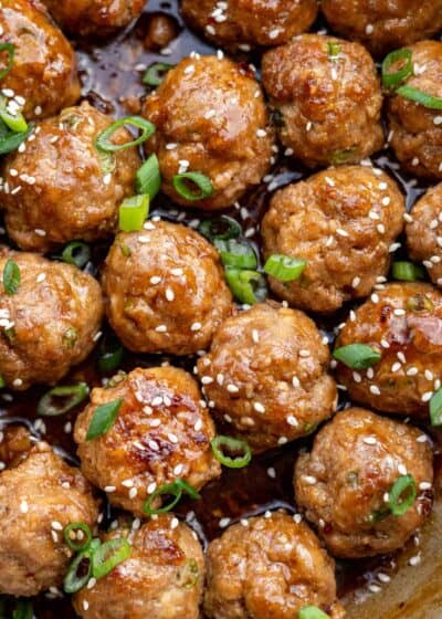 a close up shot of cooked meatballs in a skillet