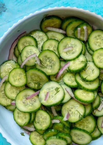 overhead image of cucumber dill salad in white bowl