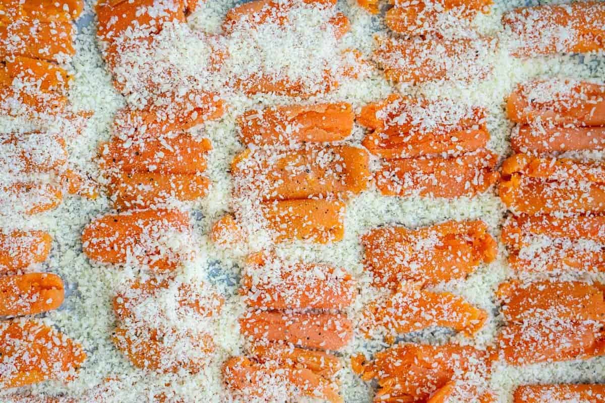 smashed carrots on a sheet pan with parmesan