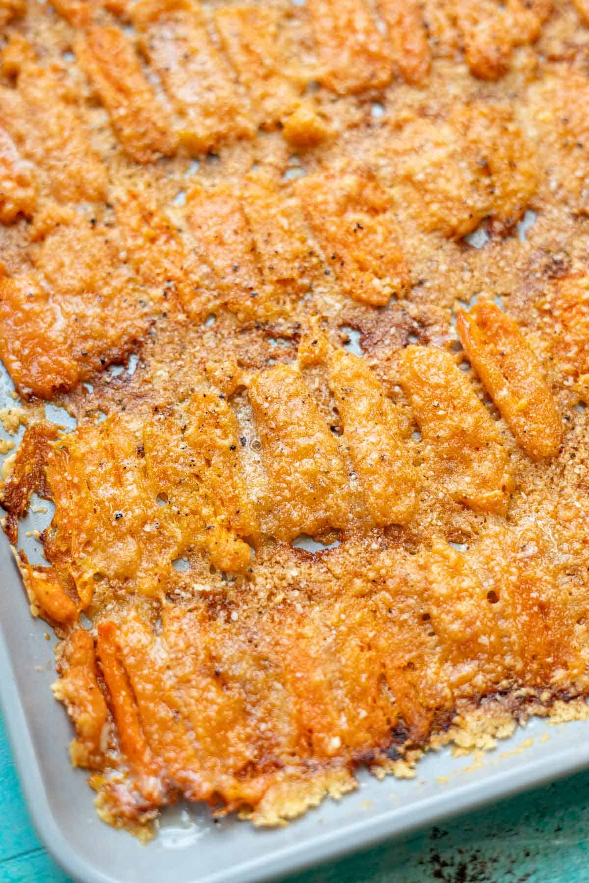 close up image of smashed carrots on sheet pan