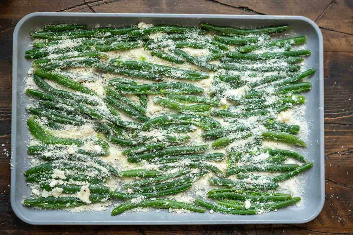 smashed green beans and parmesan on baking sheet prior to being cooked