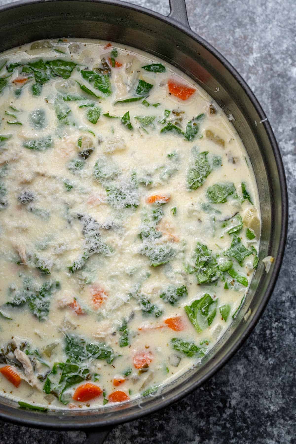 prepared chicken florentine soup in a black dutch oven