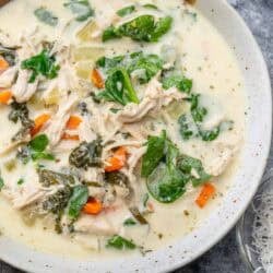 overhead image of chicken florentine soup in a white bowl
