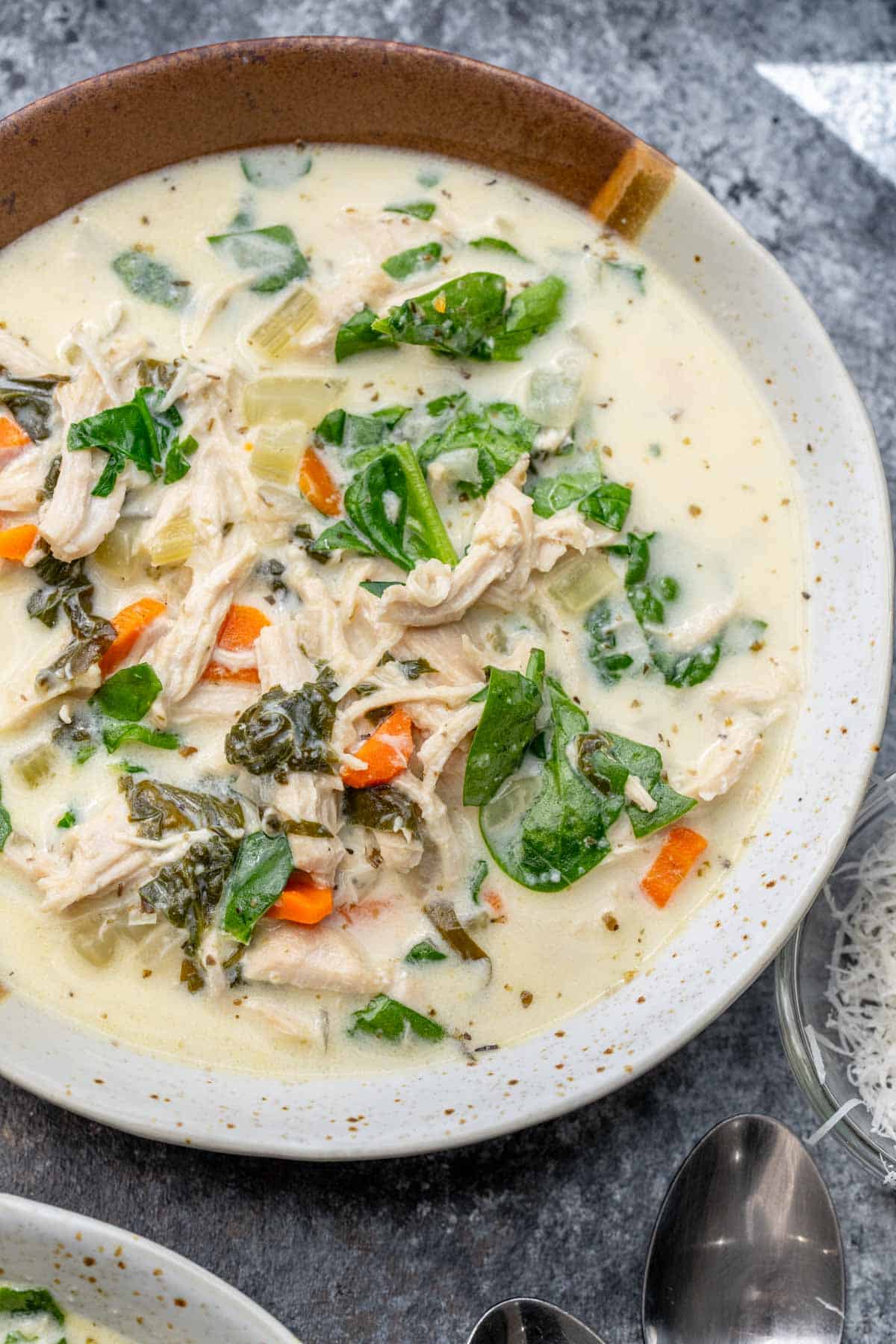 overhead image of chicken florentine soup in a white bowl