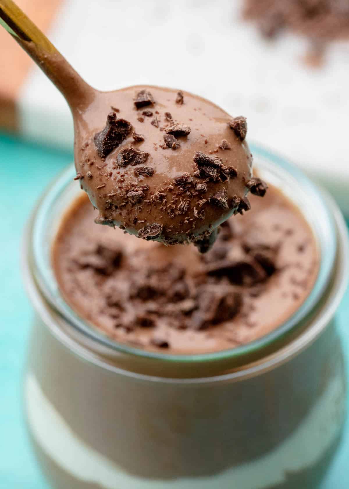 a spoonful of cottage cheese chocolate mousse being removed from jar