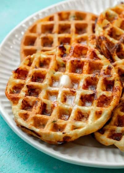 overhead, angled image of 3 protein waffles on a white plate