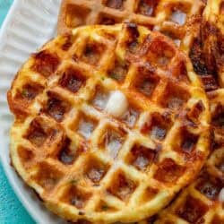 close up image of protein waffles stacked on a white plate