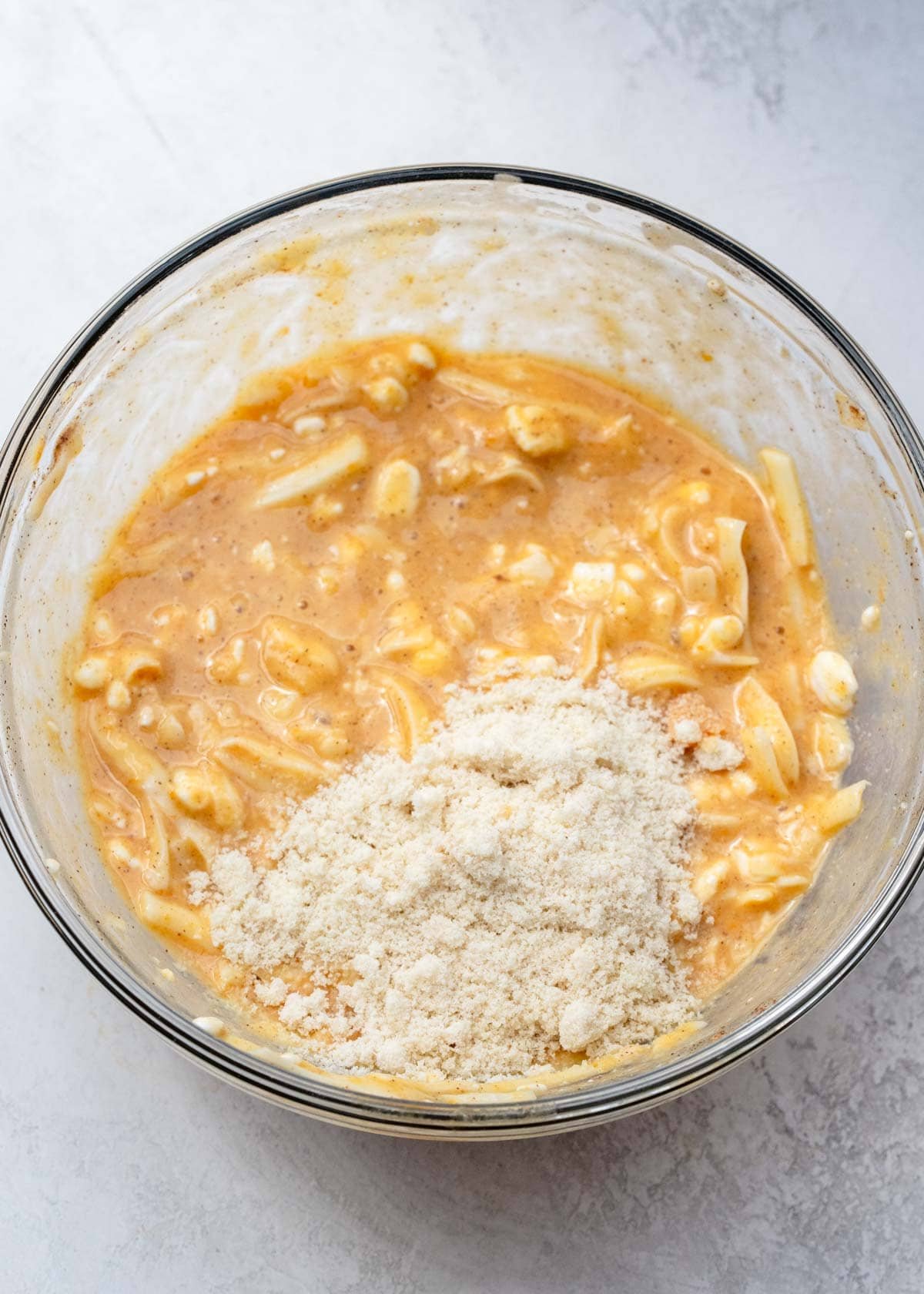 pumpkin chaffle ingredients after being mixed into a batter in clear mixing bowl