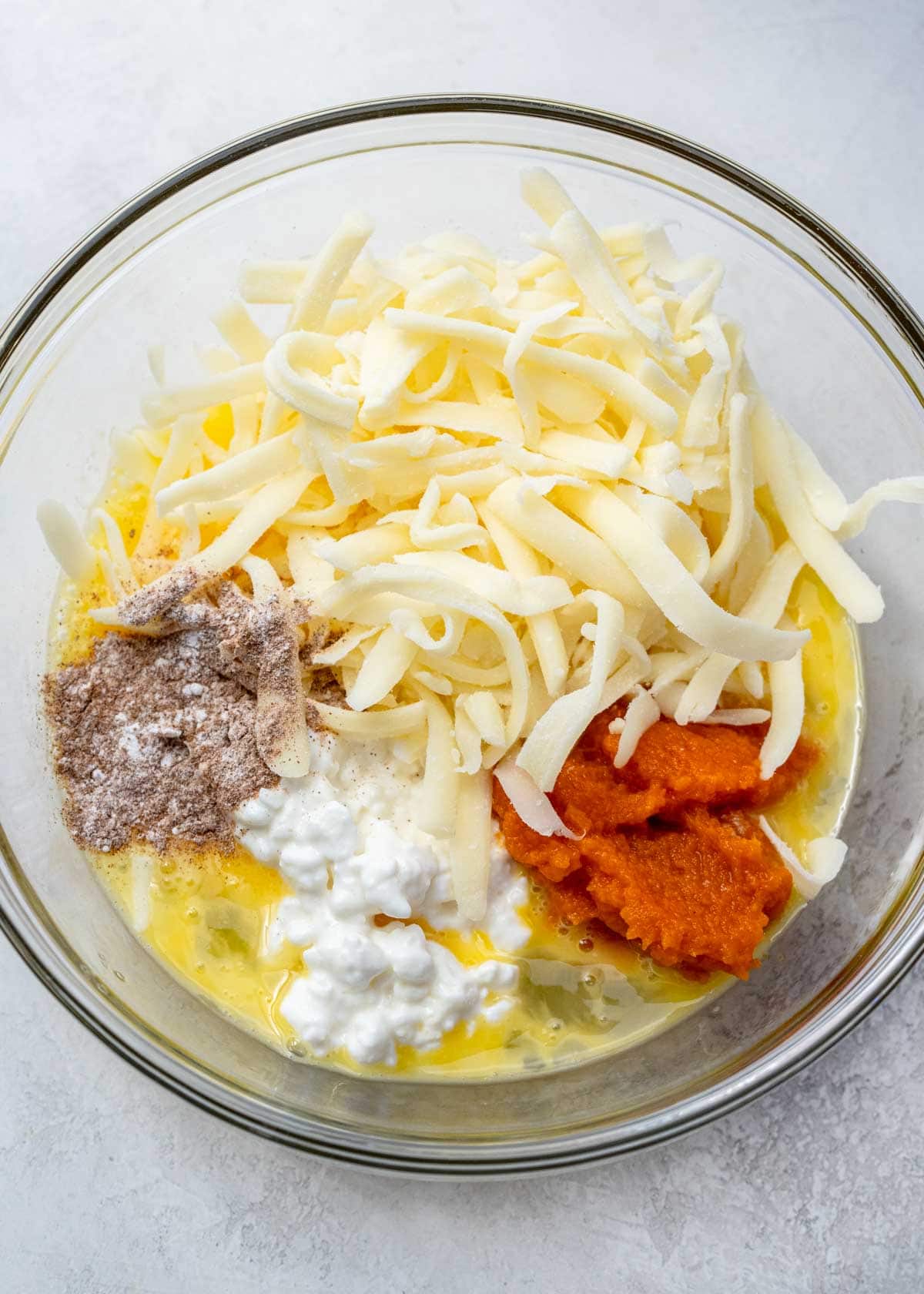 pumpkin chaffle ingredients in a clear mixing bowl