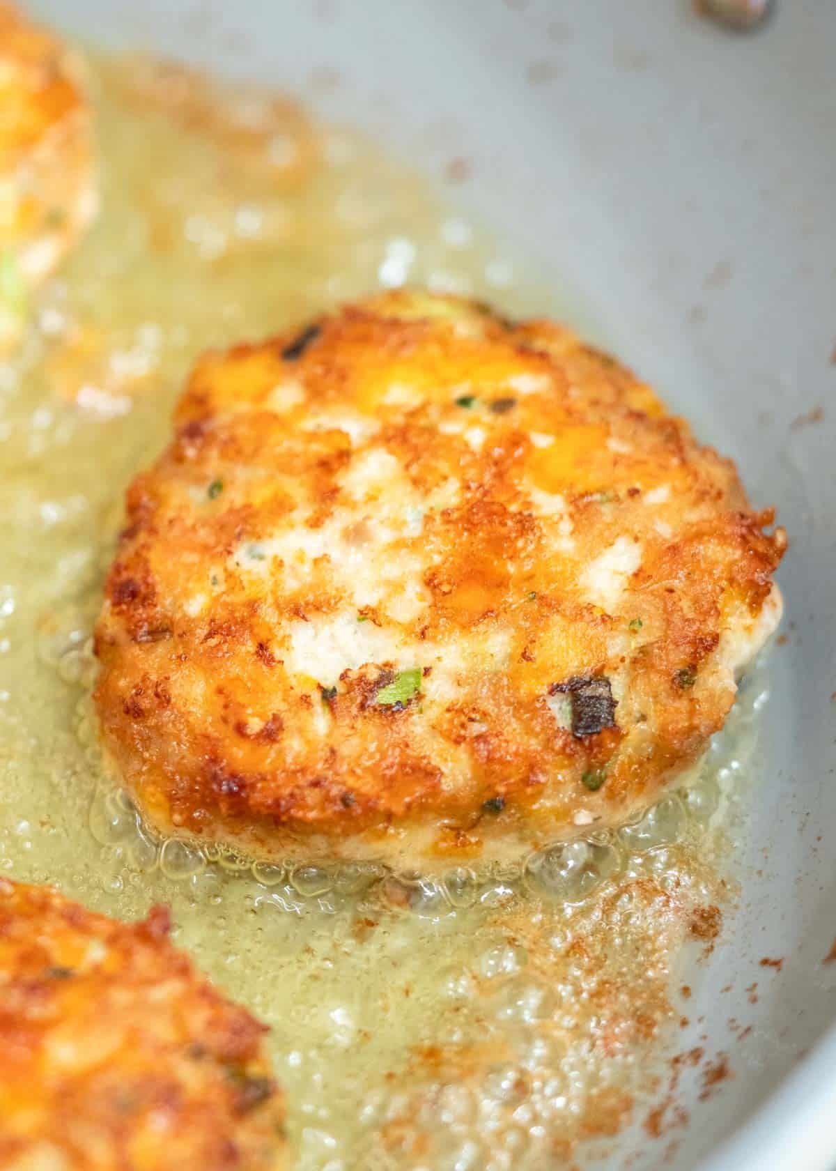 chicken fritters cooking in skillet