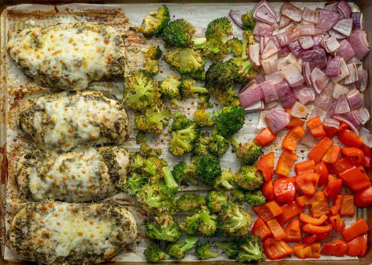 cooked sheet pan pesto chicken and veggies in a sheet pan