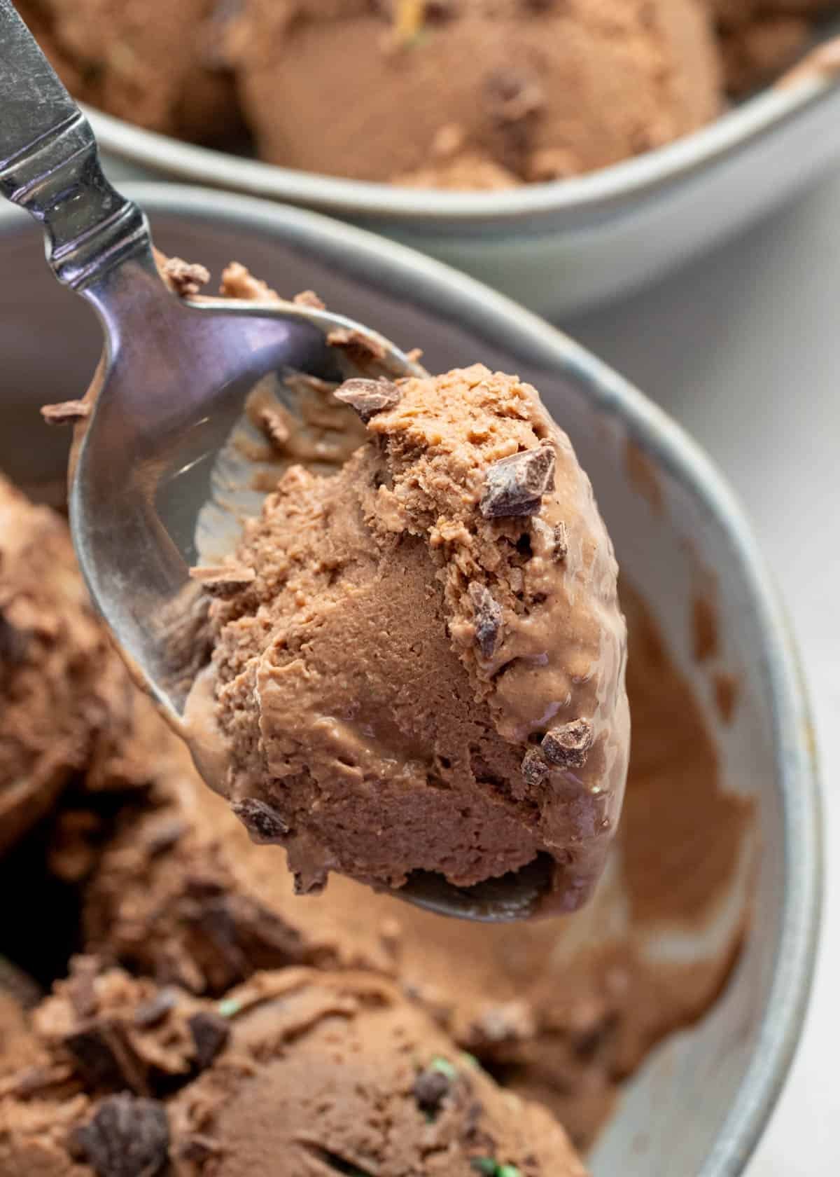 a spoonful of cottage cheese ice cream being removed from white bowl