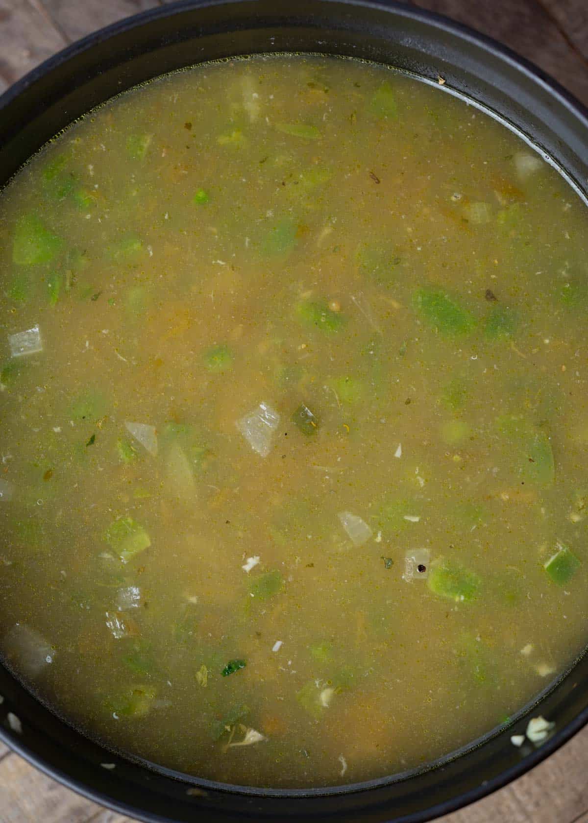 broth and ranch seasoning being added to dutch oven