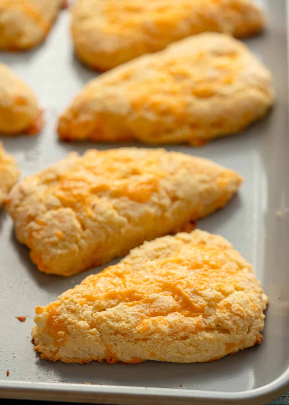 close image of three cooked gluten free scones on a baking sheet