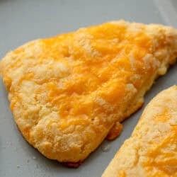 close image of two cheese scones on baking sheet
