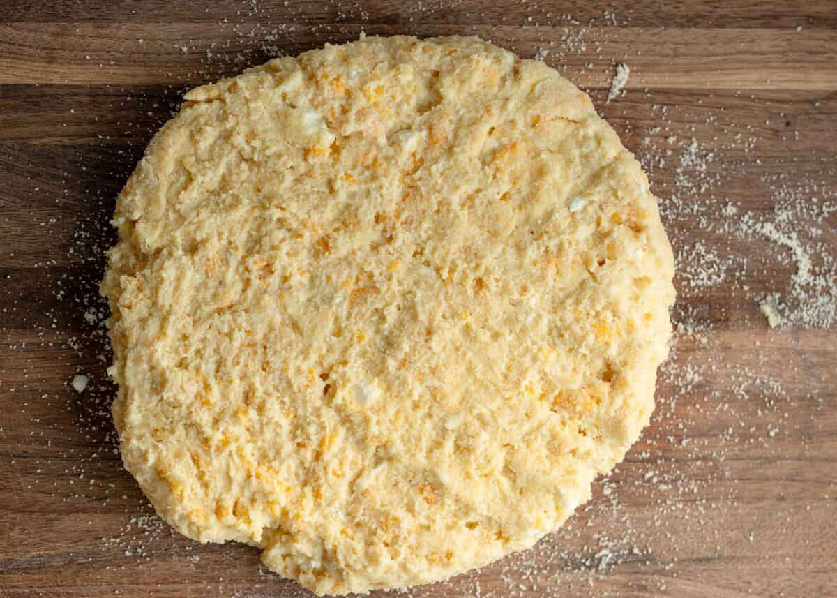 gluten free scone dough on a wooden cutting board