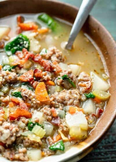 overhead image of italian sausage soup in a brown bowl