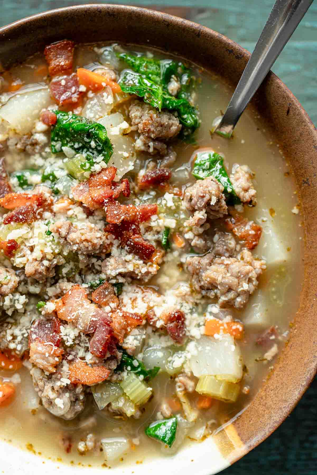 close, overhead image of italian sausage soup in a brown bowl