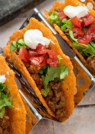 close up image of a keto taco topped veggies on a cooling rack