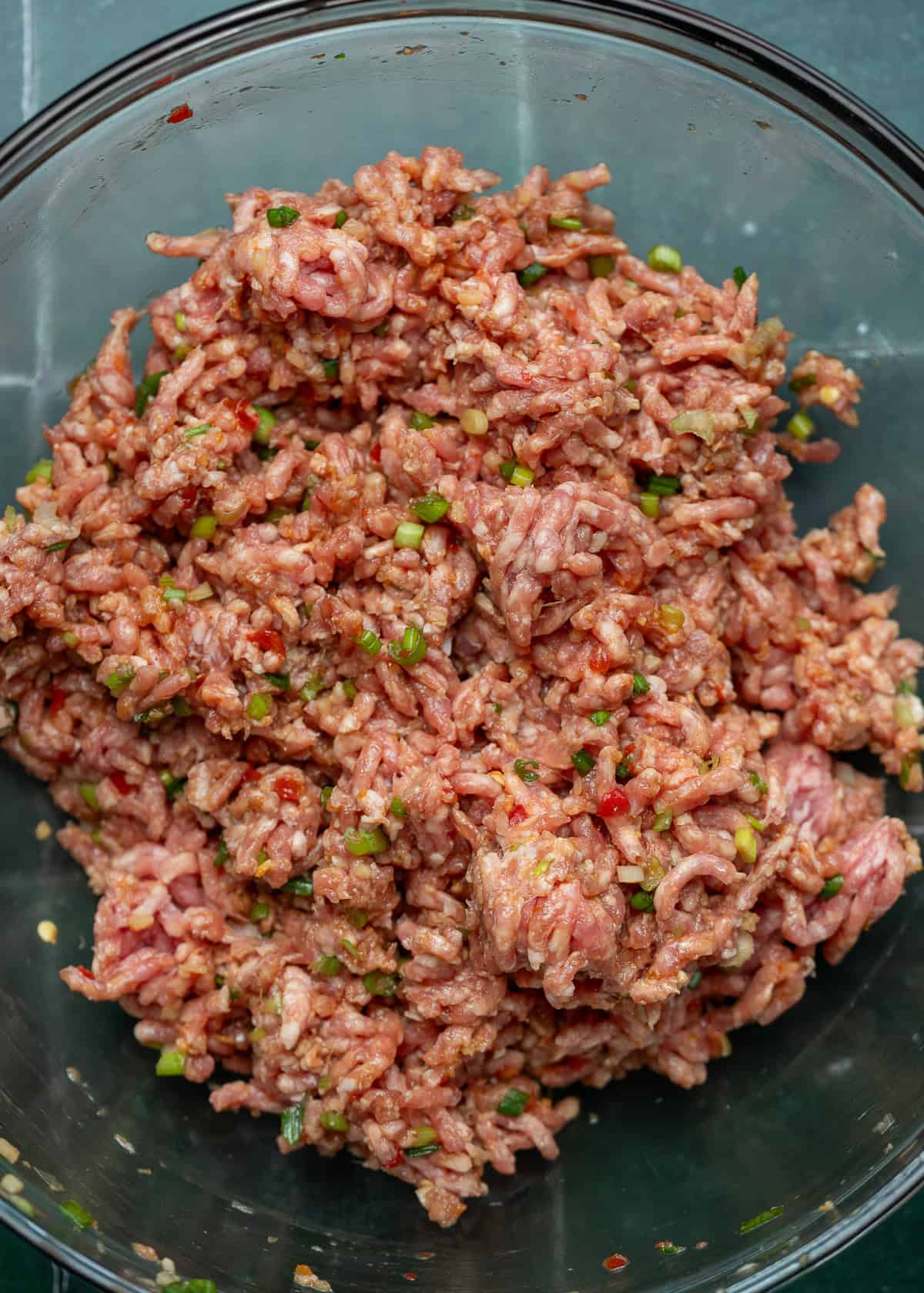 pork dumpling filling ingredients in a clear mixing bowl