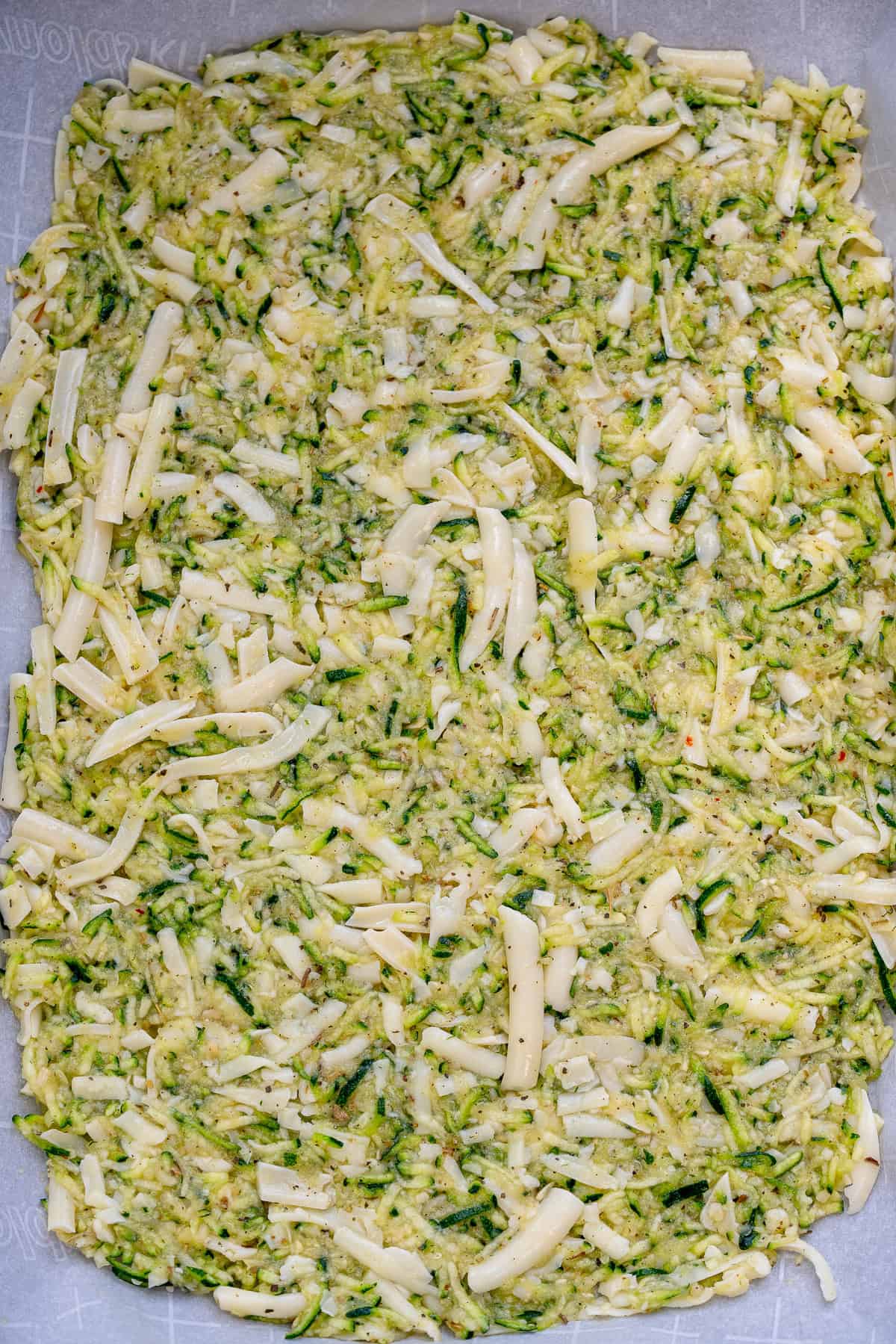 zucchini breadstick ingredients patted out on a cutting board