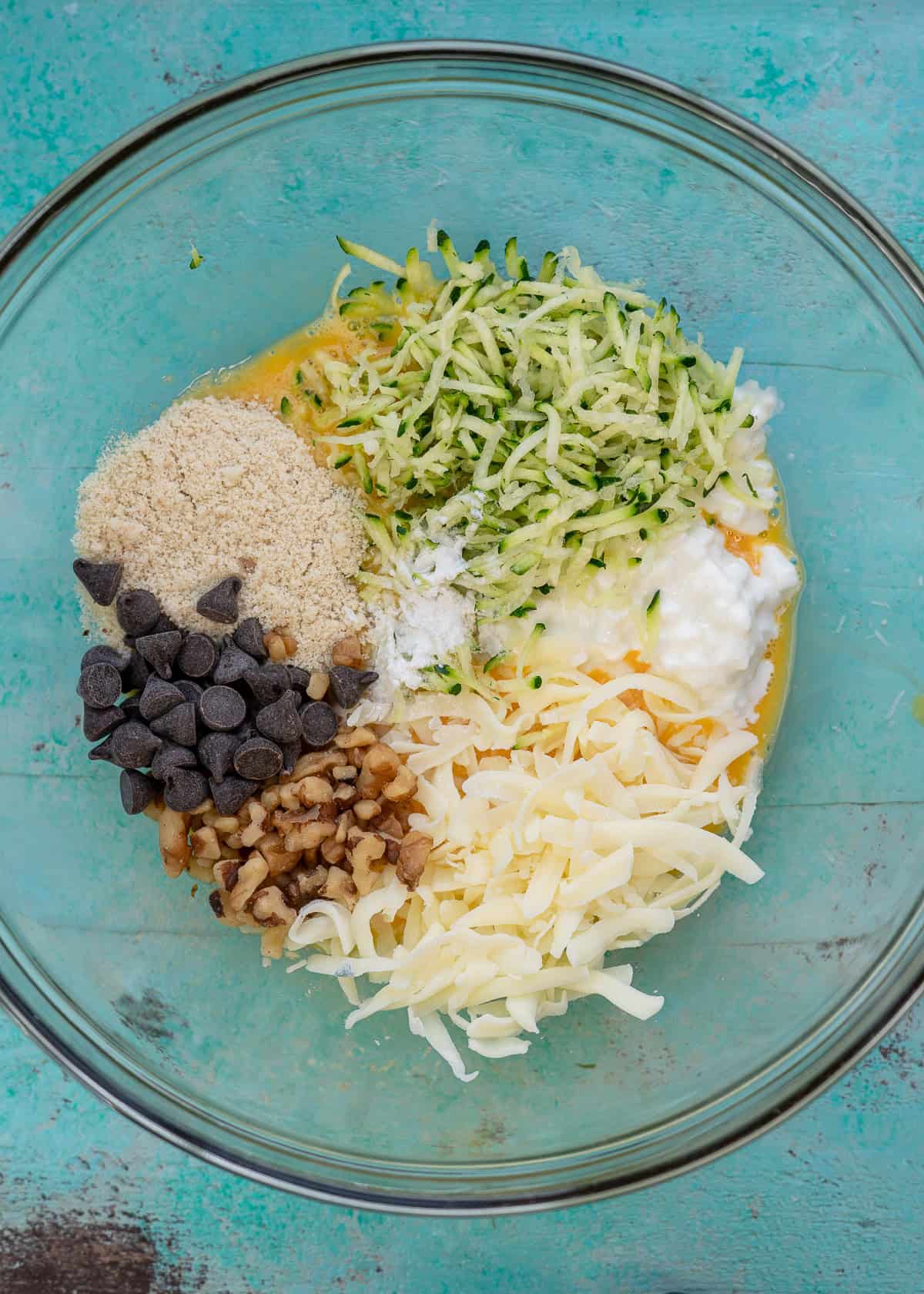 zucchini bread chaffle ingredients in a clear mixing bowl