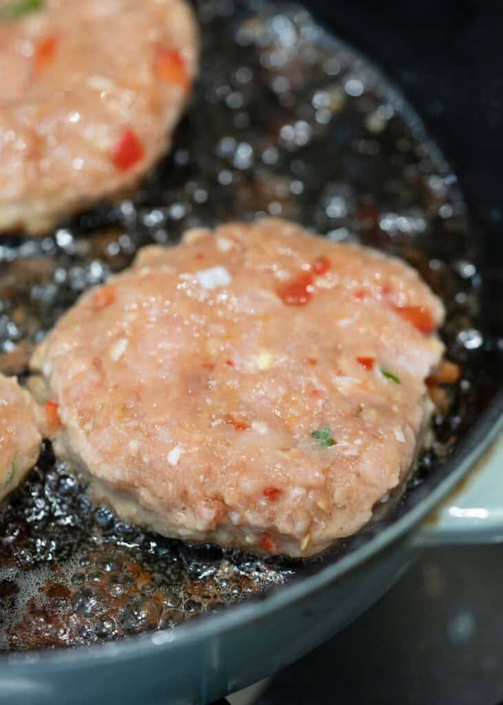uncooked chicken fritters in a skillet