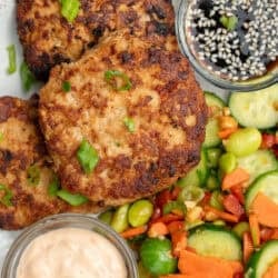 overhead shot of asian chicken fritters with cucumber salad on the side