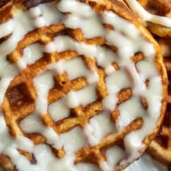 close up image of a keto cinnamon roll chaffle on a white plate